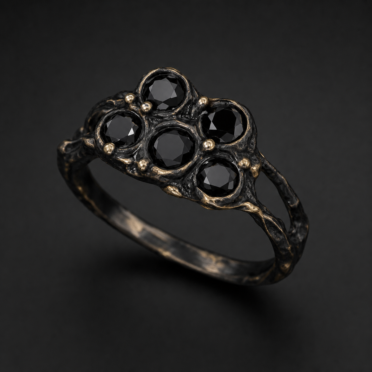 Photograph of a blackened gold ring with black diamonds